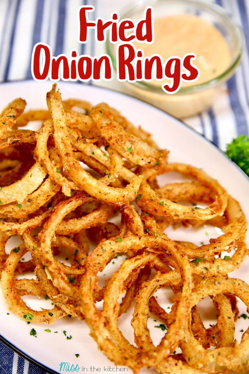 Platter of crispy fried onion rings. Text overlay.
