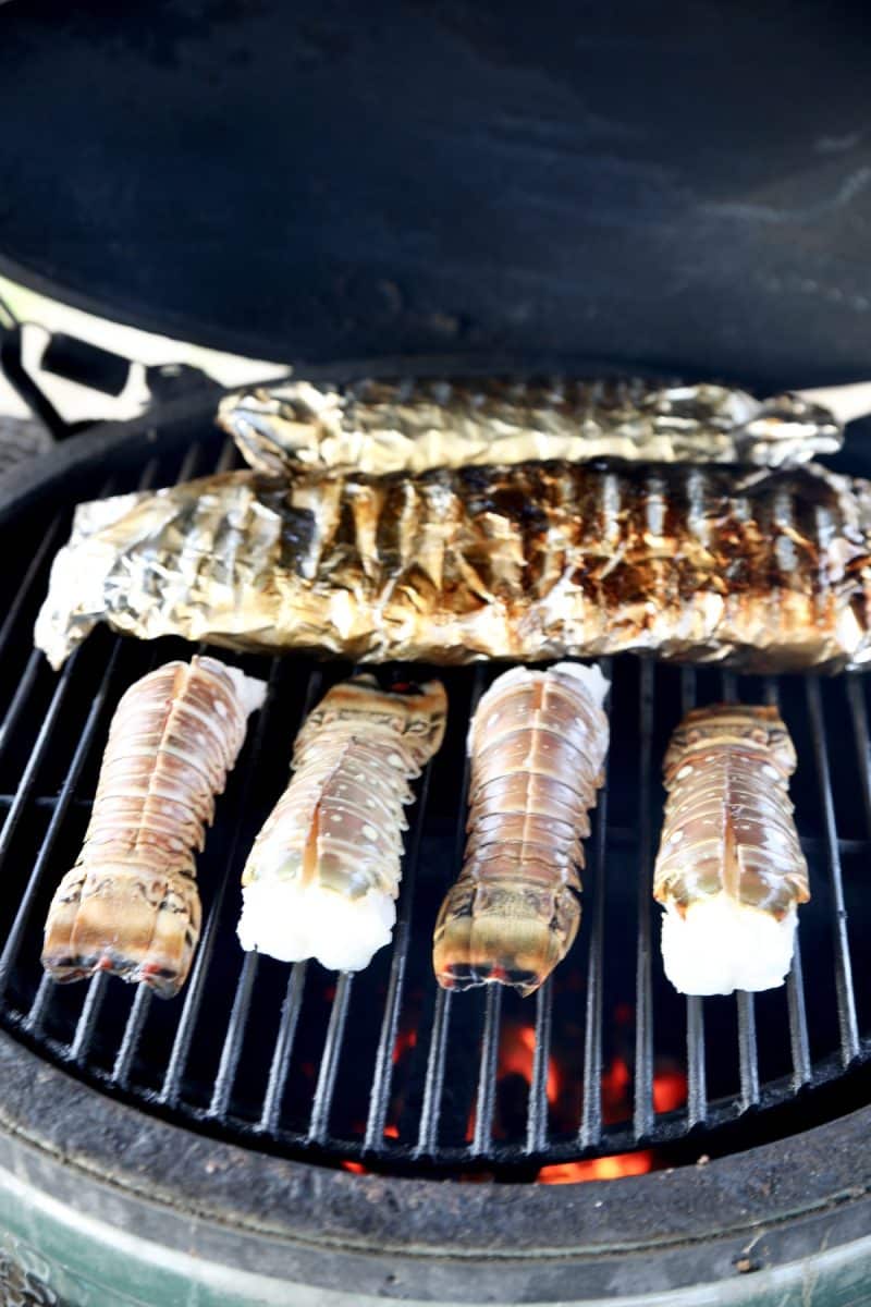 Cooking lobster tails on a grill.