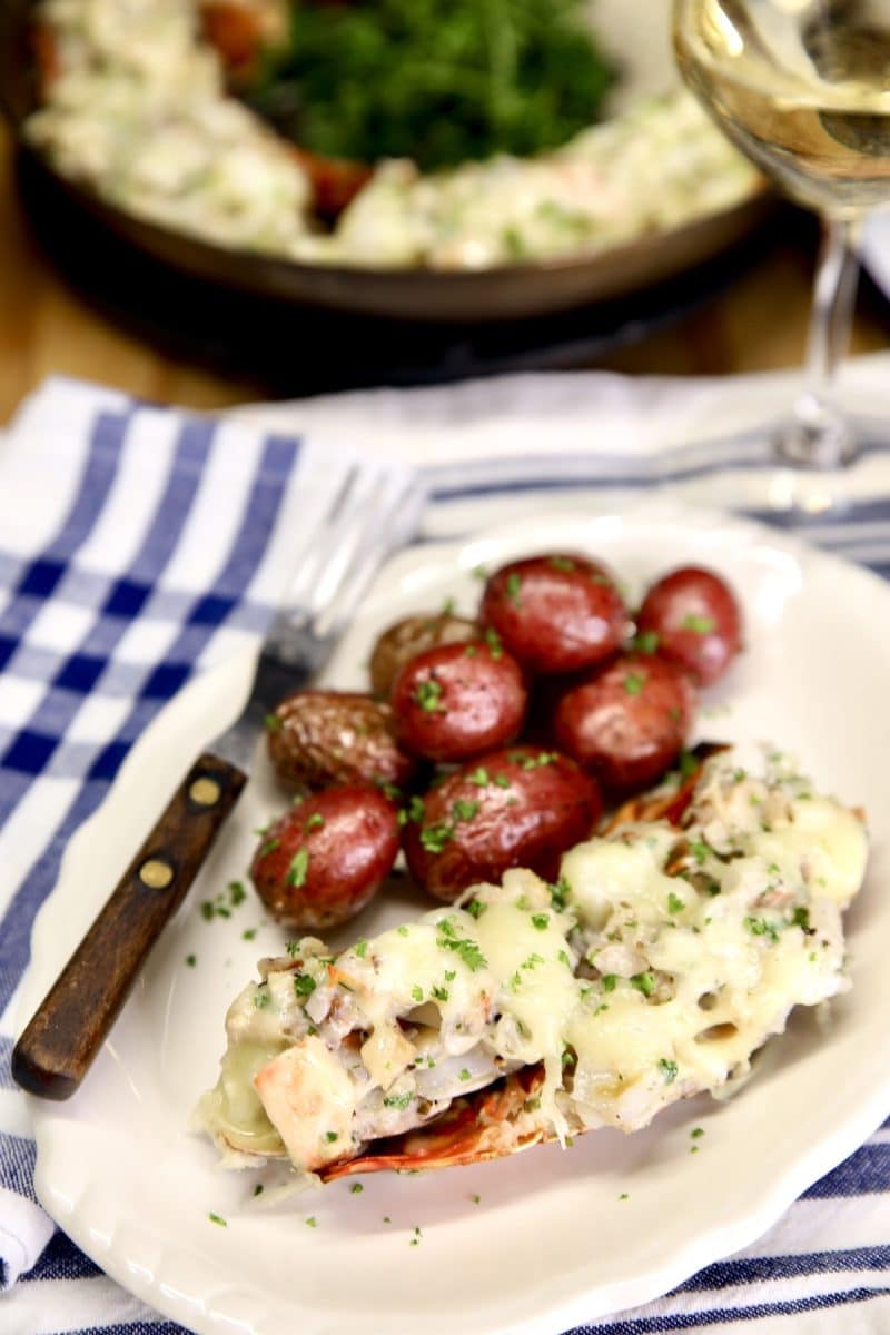 Lobster Thermidor on a plate with baby red potatoes.
