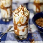 No Bake Coconut Cheesecake with caramel in dessert glasses.