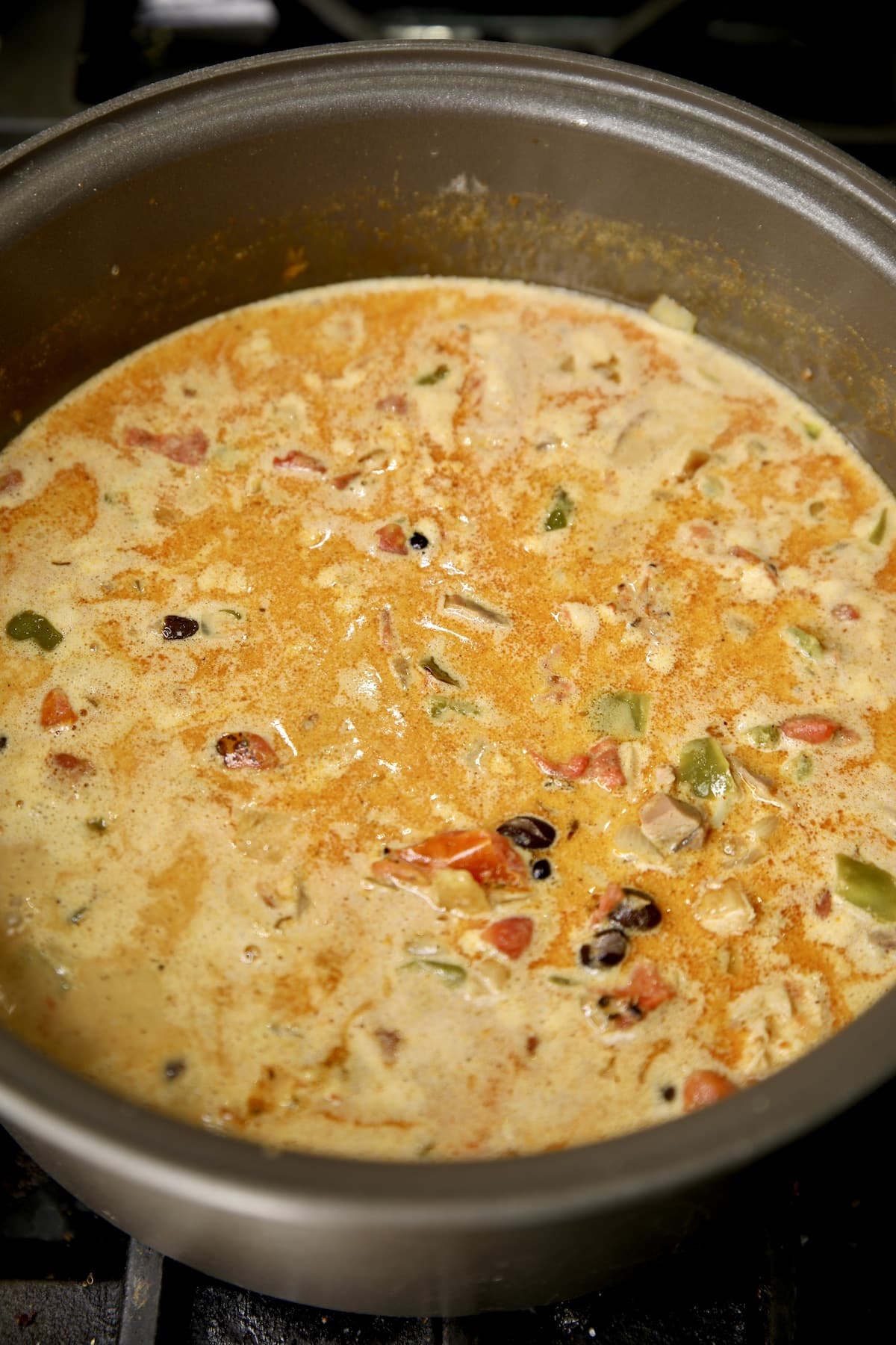 Simmering pot of chicken enchilada soup.