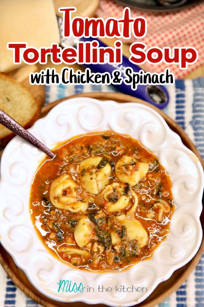 Bowl of tortellini tomato soup with chicken and spinach. Text overlay.