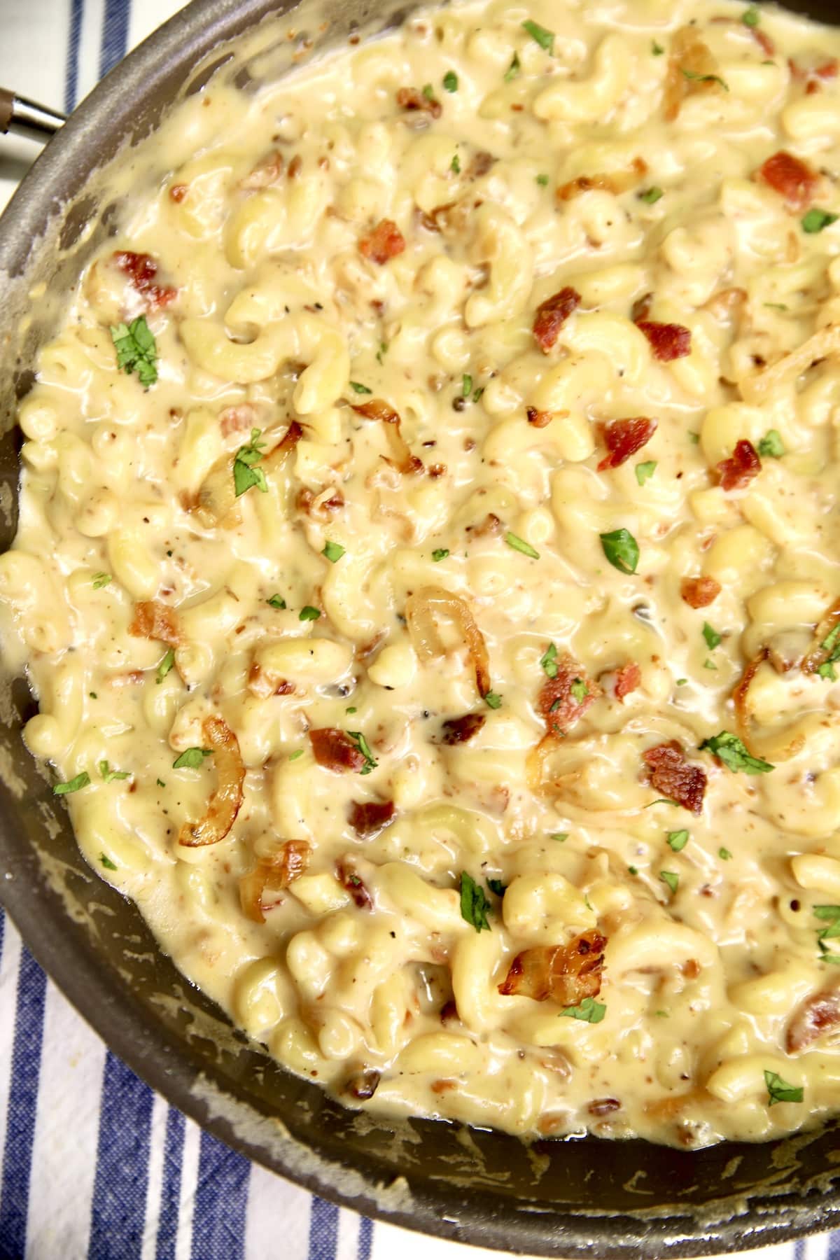 Pan of macaroni and cheese with onions and bacon. 
