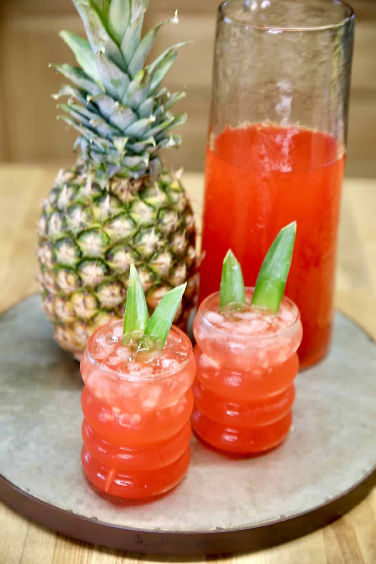 Pineapple, pitcher of punch, 2 glasses of punch.
