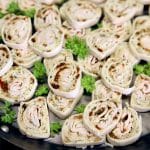 Turkey pinwheel appetizers on a platter.
