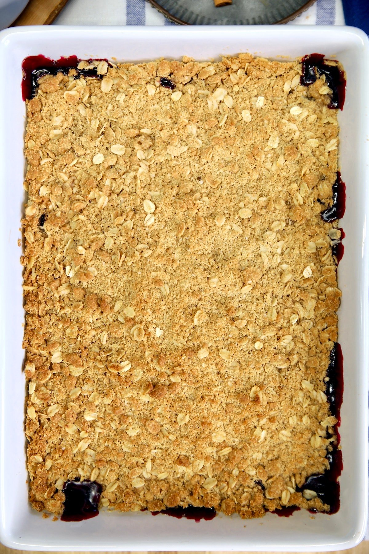 Baked blueberry crisp in a rectangle dish.