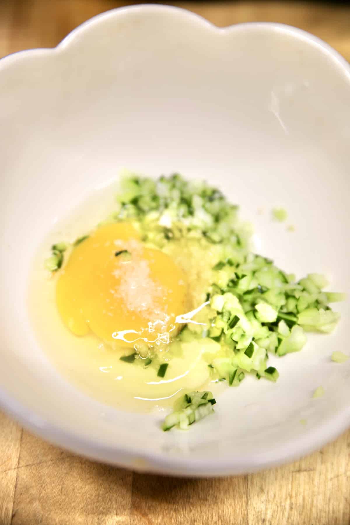 Bowl with egg, cucumber, salt, vinegar.