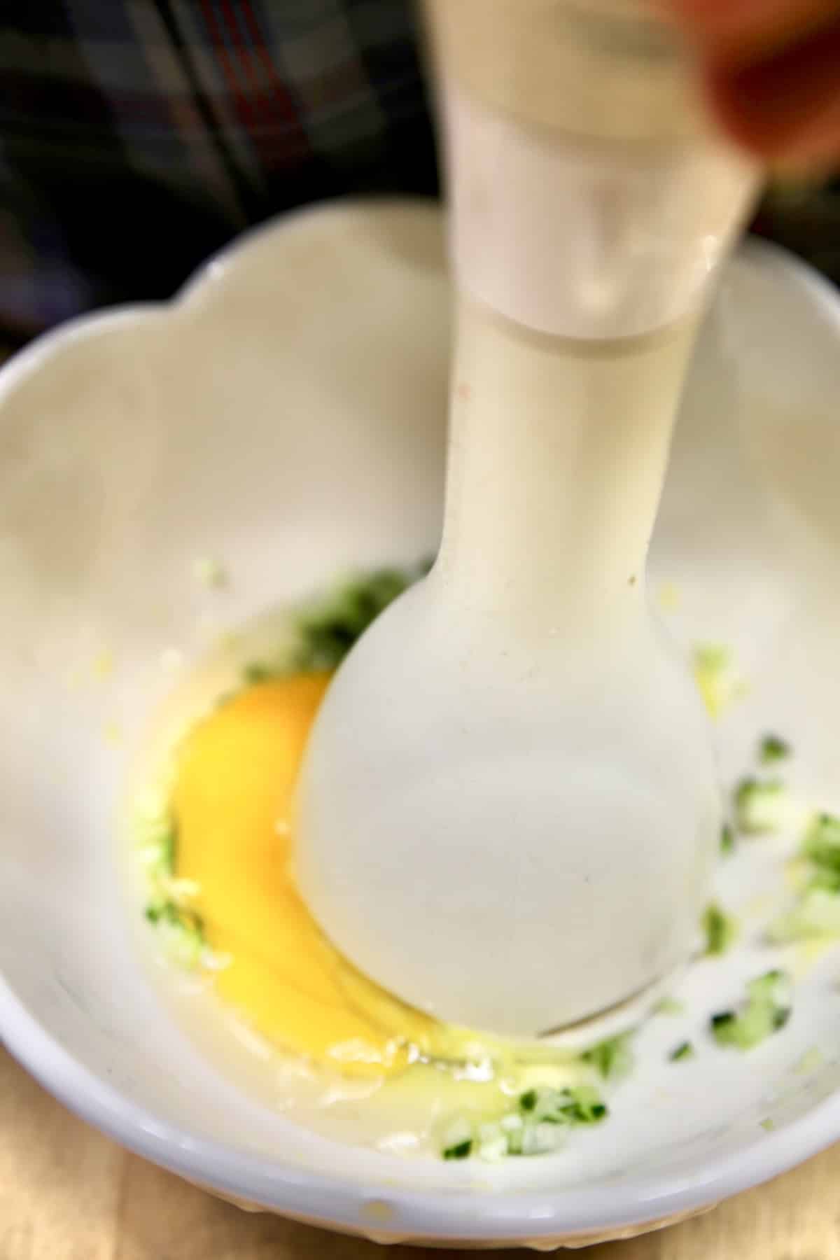 Blending egg for homemade mayo with stick blender.