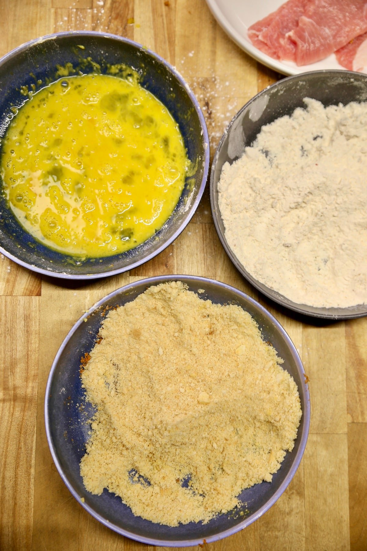 Breading station for schnitzel: egg, flour, breadcrumbs.