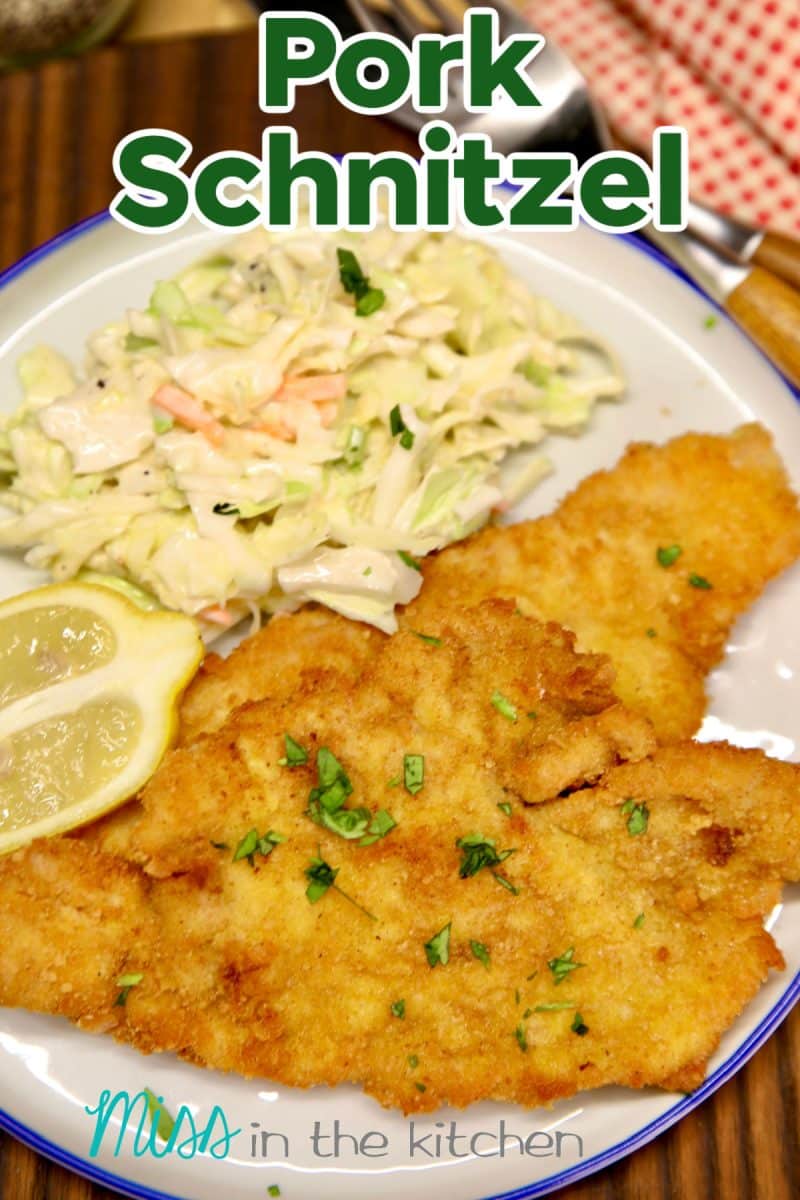 Pork Schnitzel on a plate with coleslaw. Text overlay.