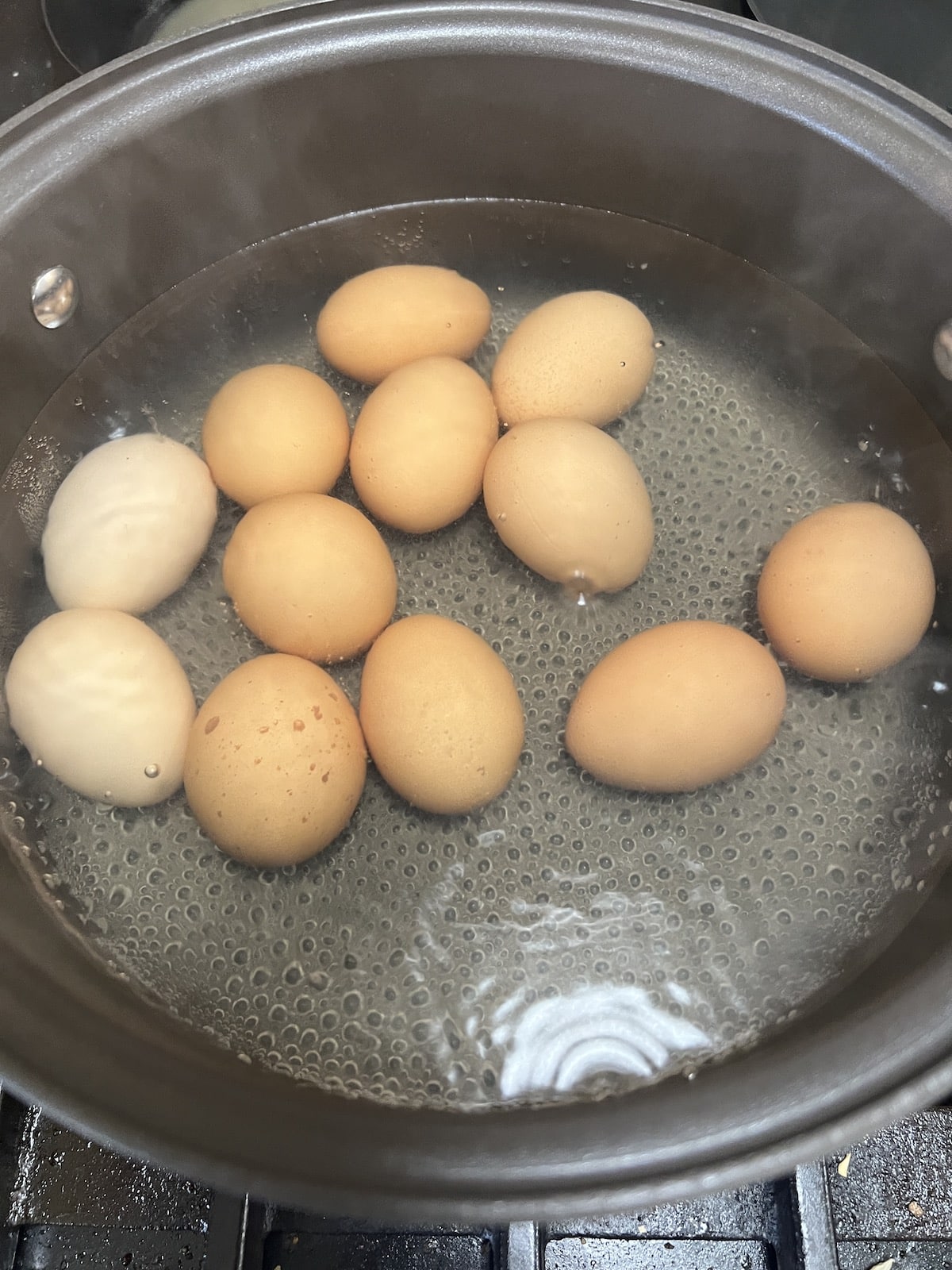 Boiling eggs in a pan.