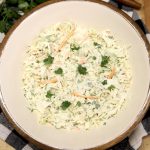 Coleslaw in a bowl with cilantro dressing.