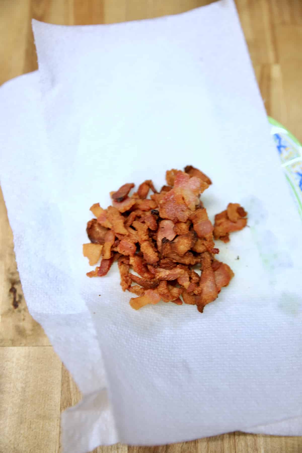 Bacon crumbles on a paper towel.