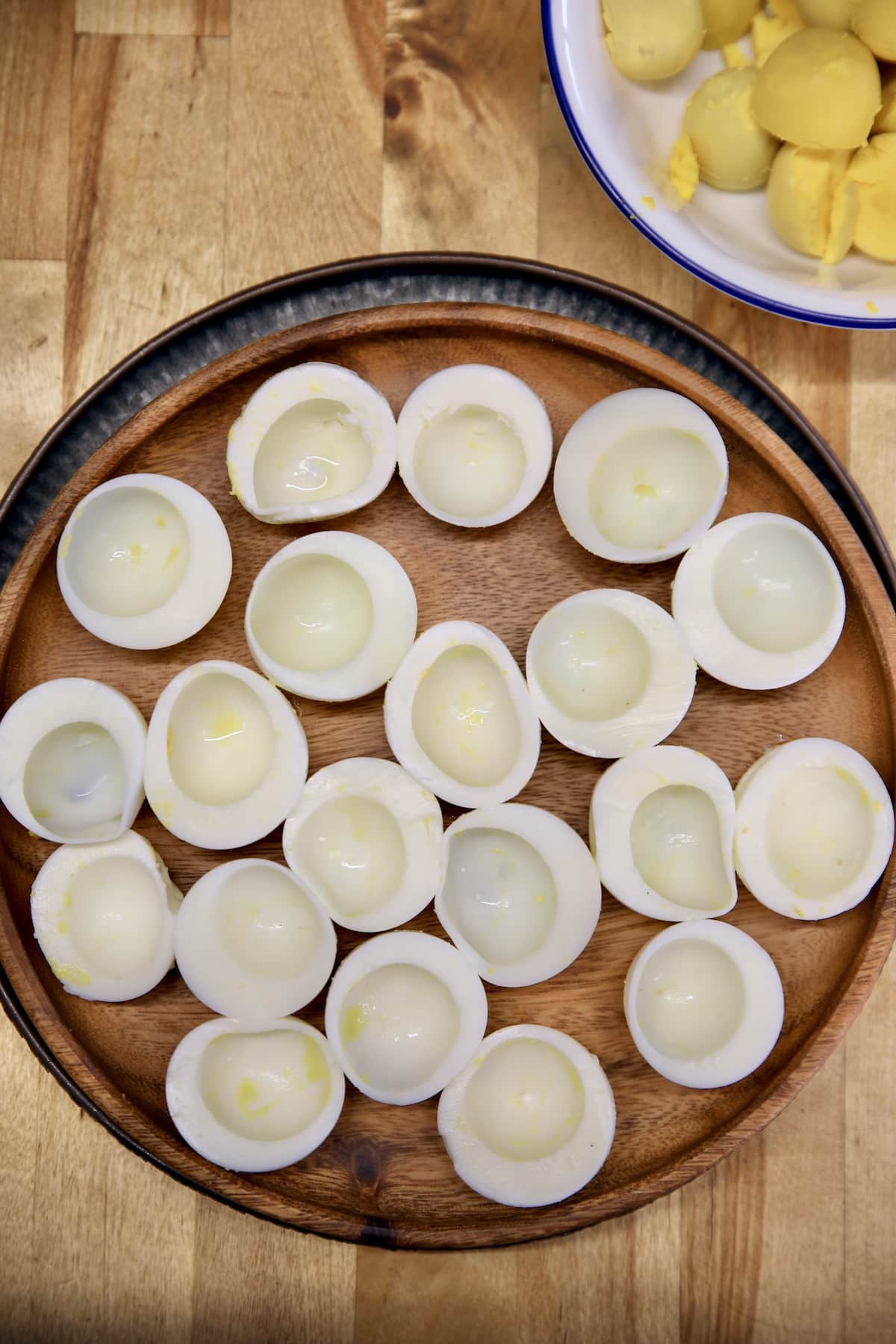Egg whites for deviled eggs on a tray.