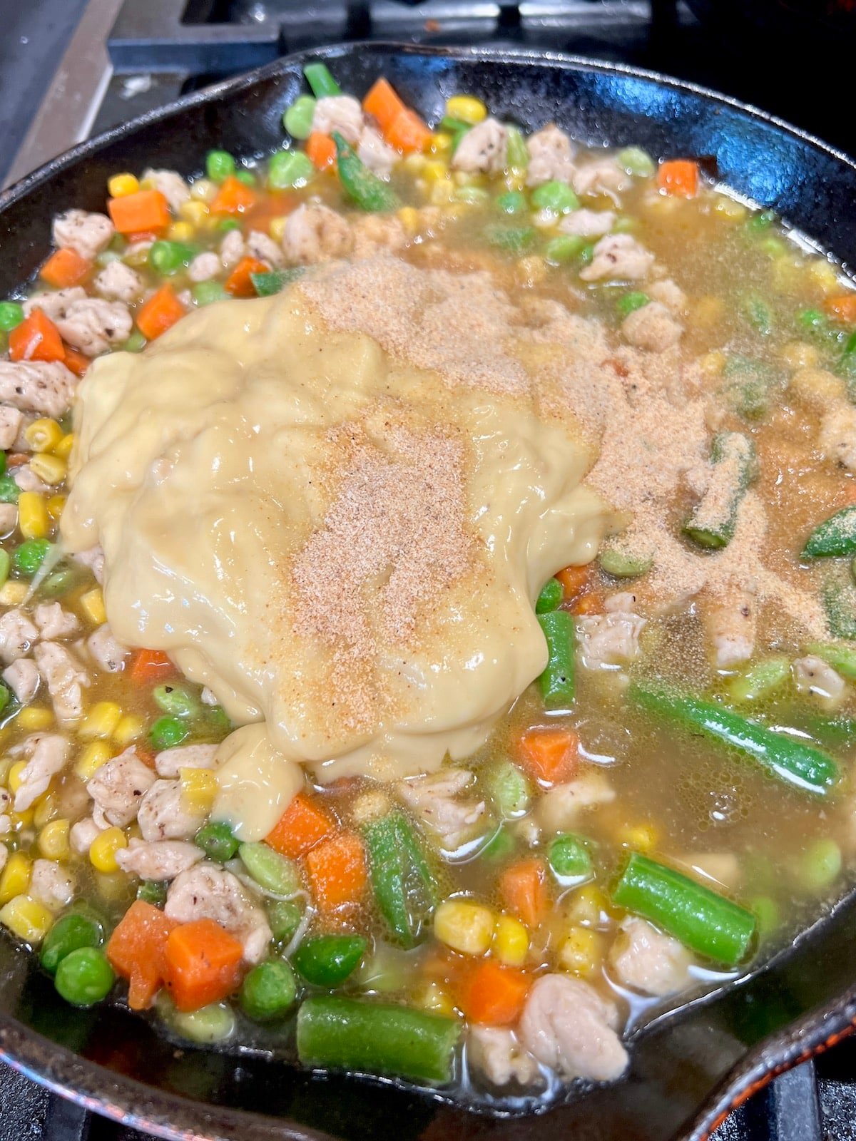 Skillet with chicken pot pie filling - not mixed.