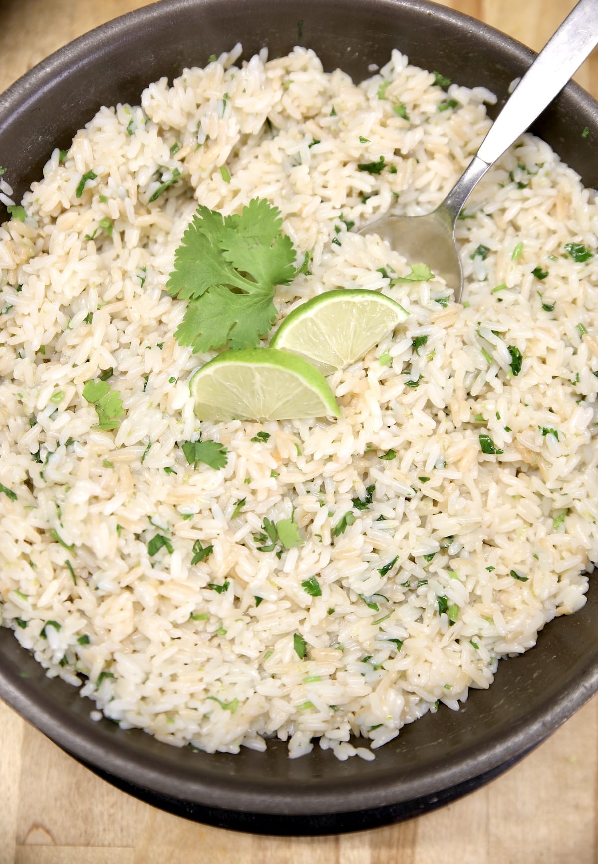 Bowl of rice with lime and cilantro.
