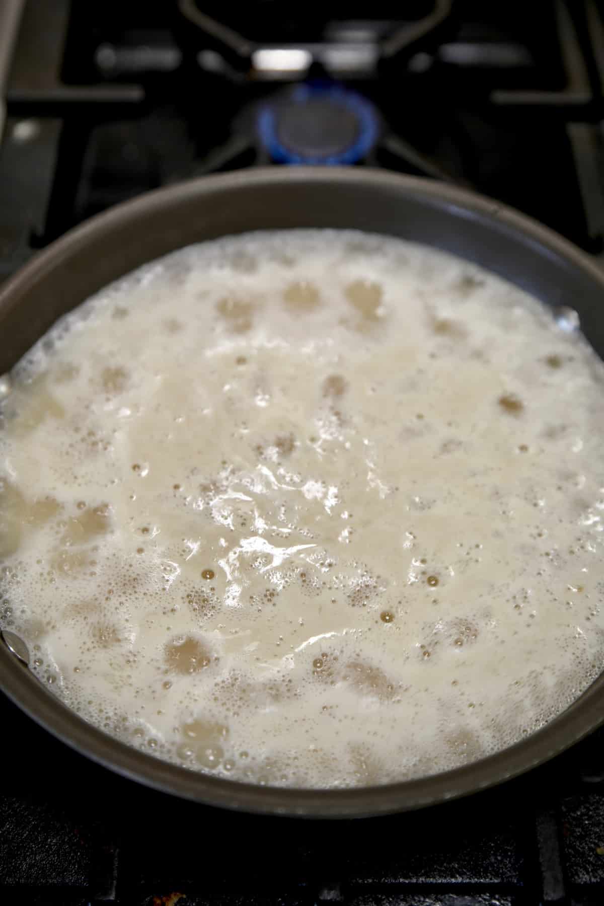 Boiling rice in a pan.