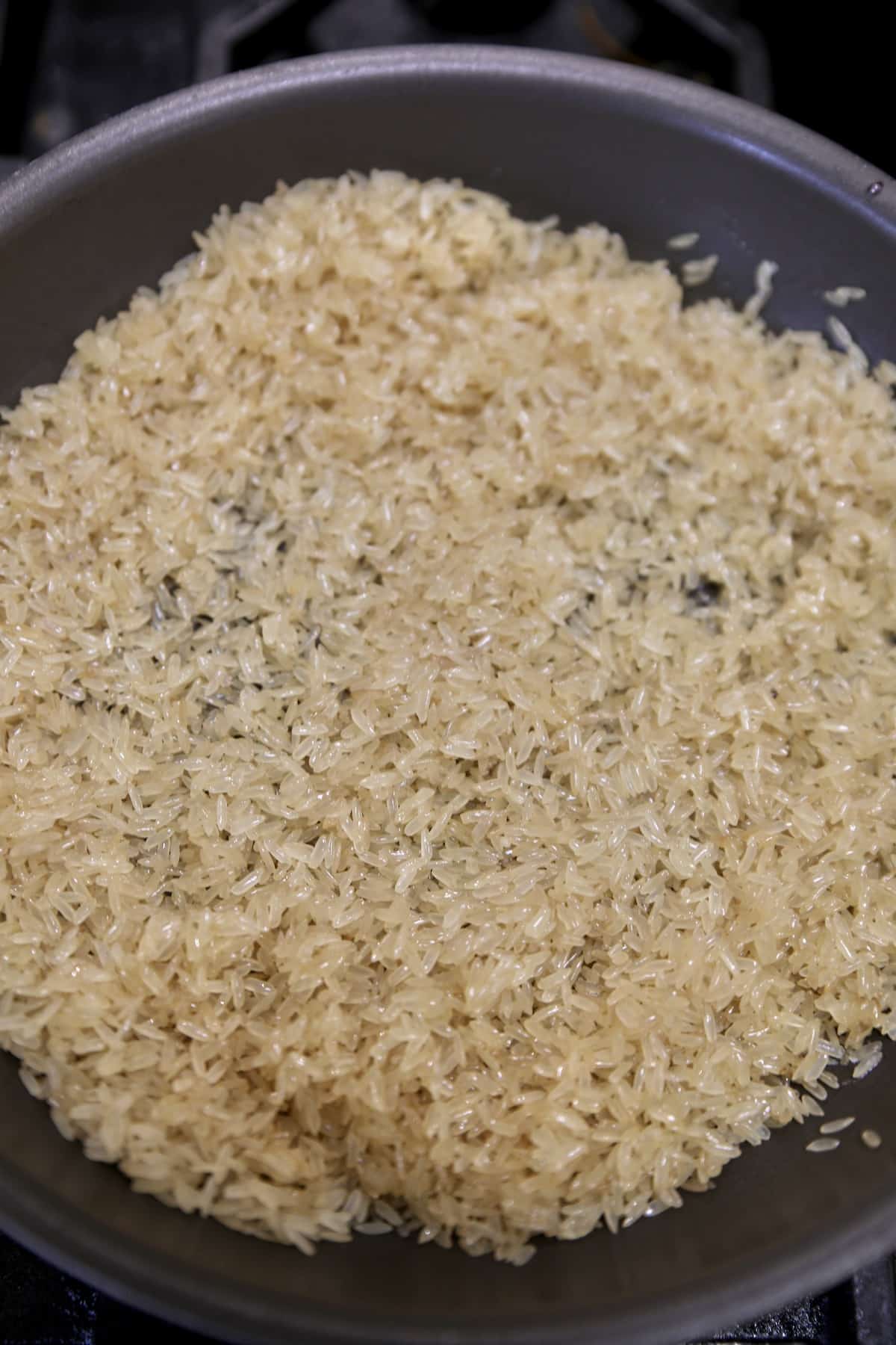 Rice toasting in a pan.