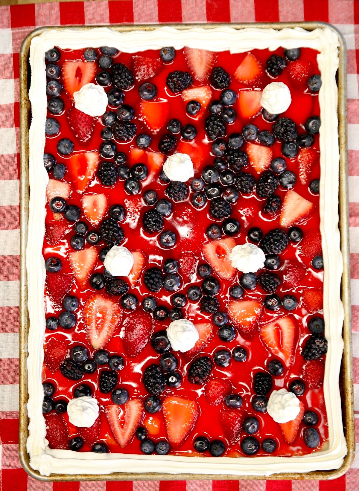 Sheet pan fresh berry pie with cool whip in a sheet pan.