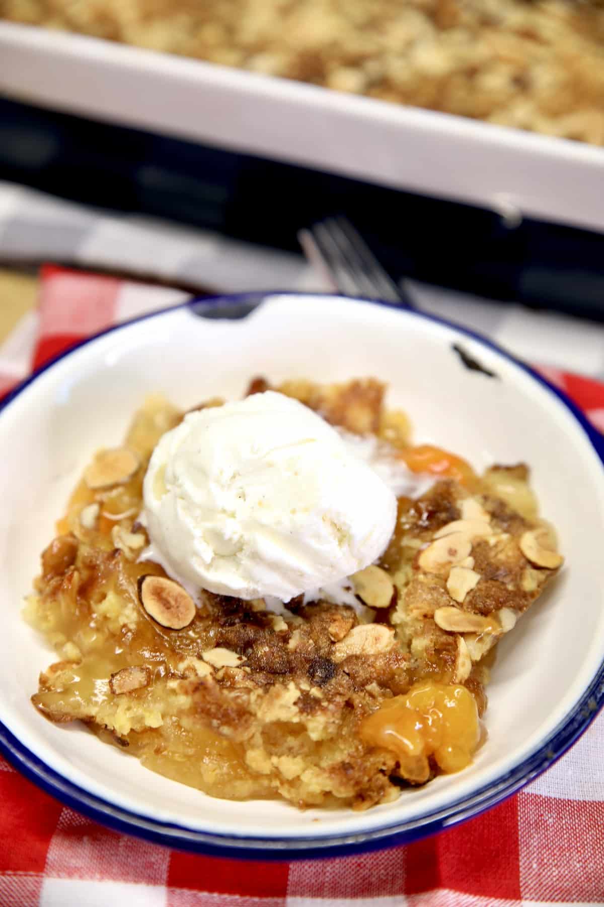 Apricot dump cake topped with vanilla ice cream.