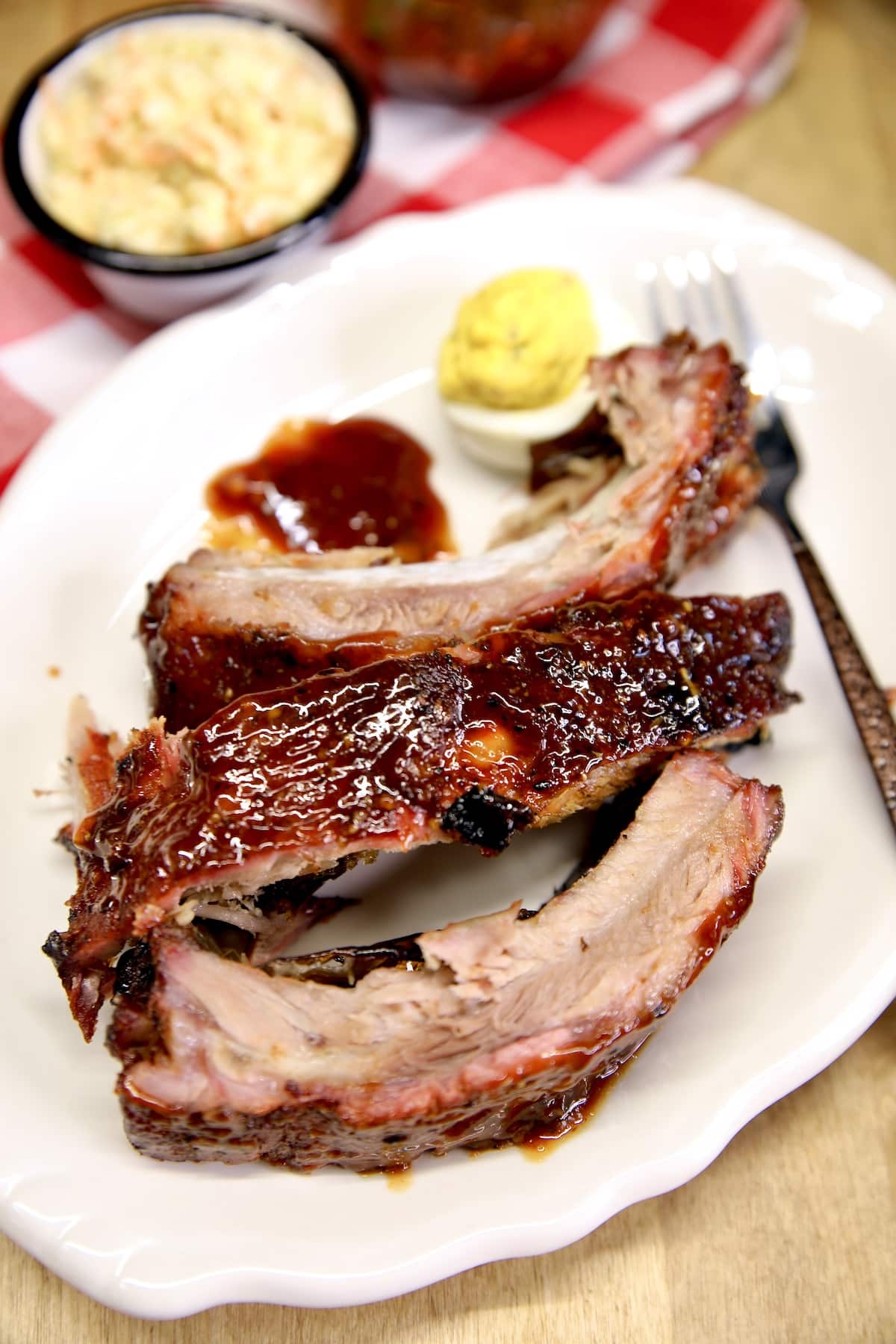 Barbecue baby back ribs on a plate.