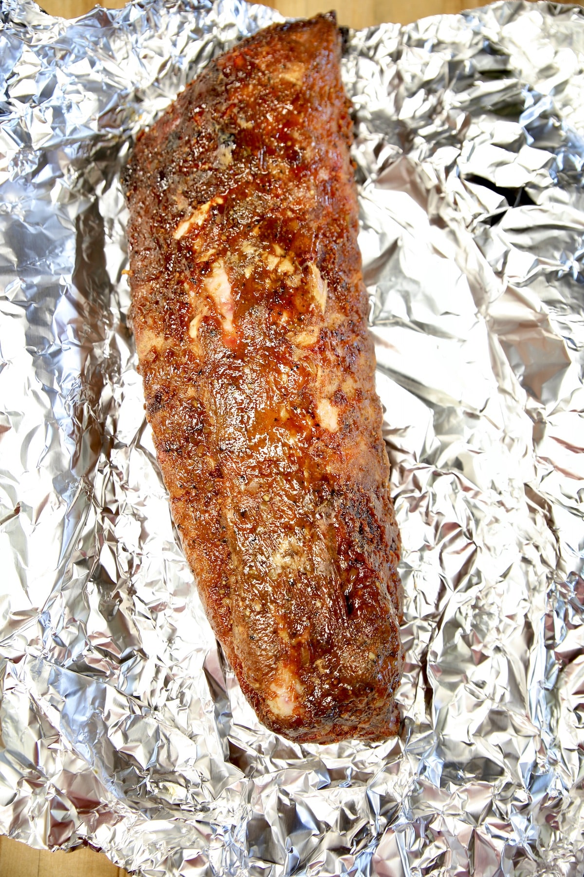 Rack of baby back ribs on foil.