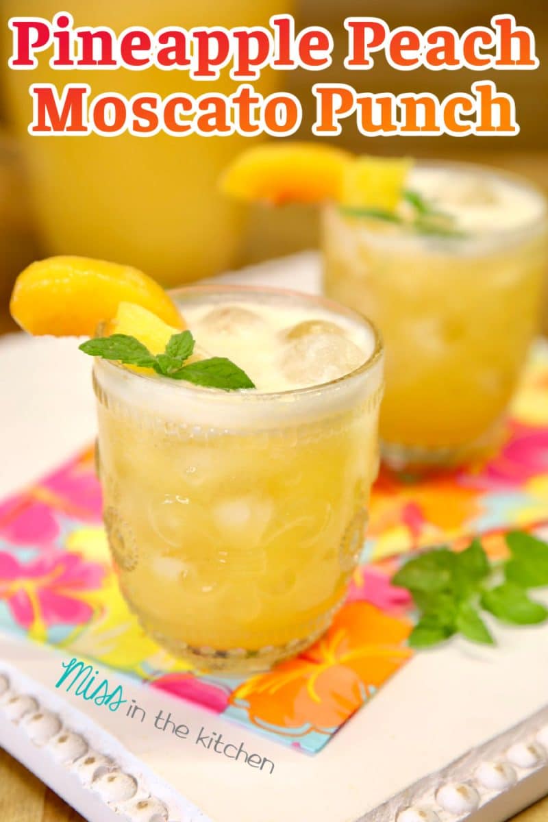 Pineapple peach moscato punch in 2 glasses- text overlay.