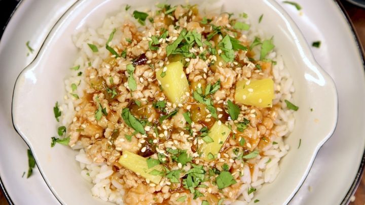 Sweet and Sour Ground Pork with pineapple and rice in a bowl.