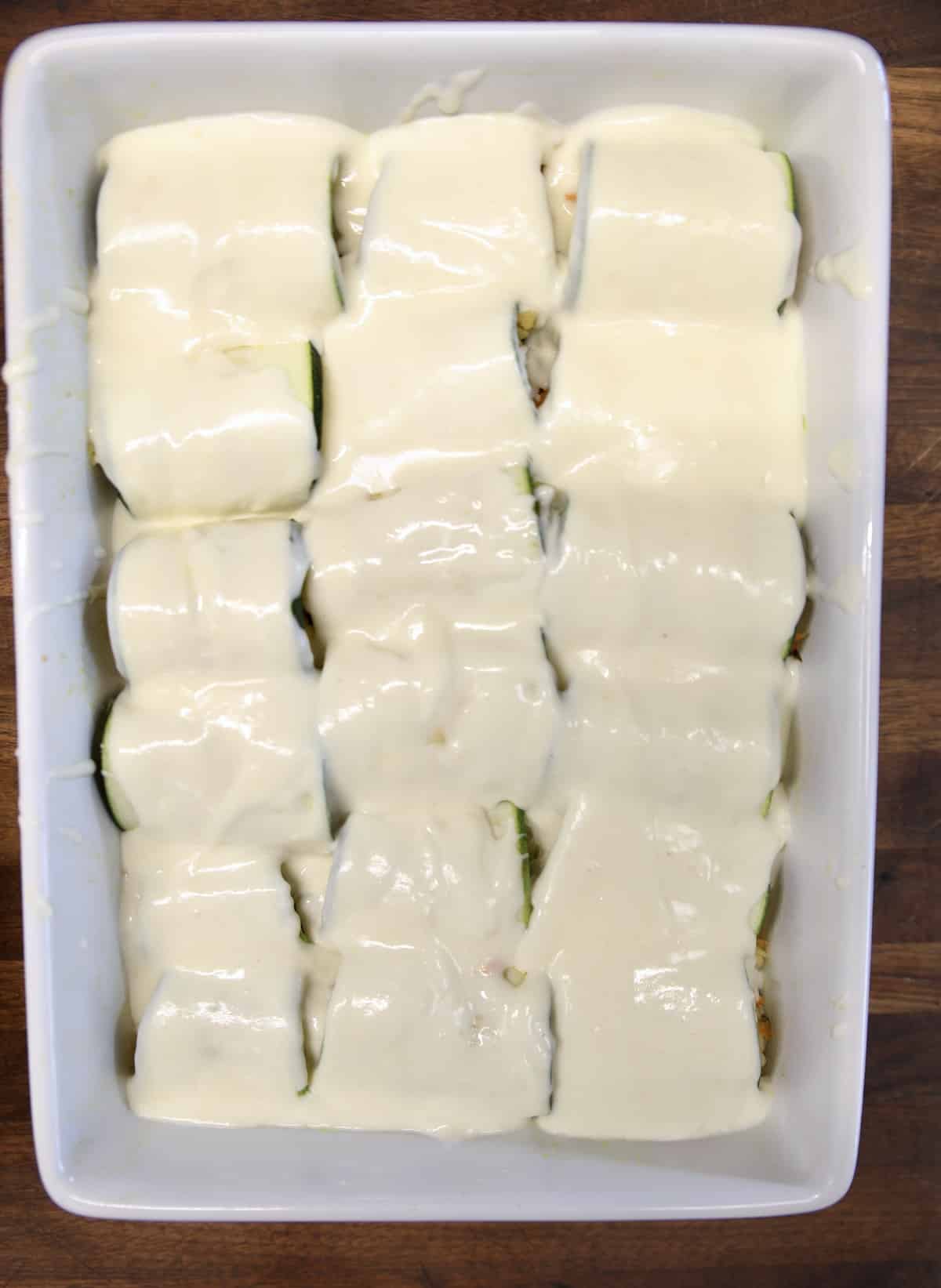 Zucchini casserole with cream sauce poured over the top.