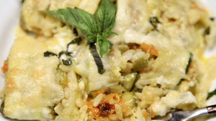 Zucchini rice casserole with a fork on a plate.