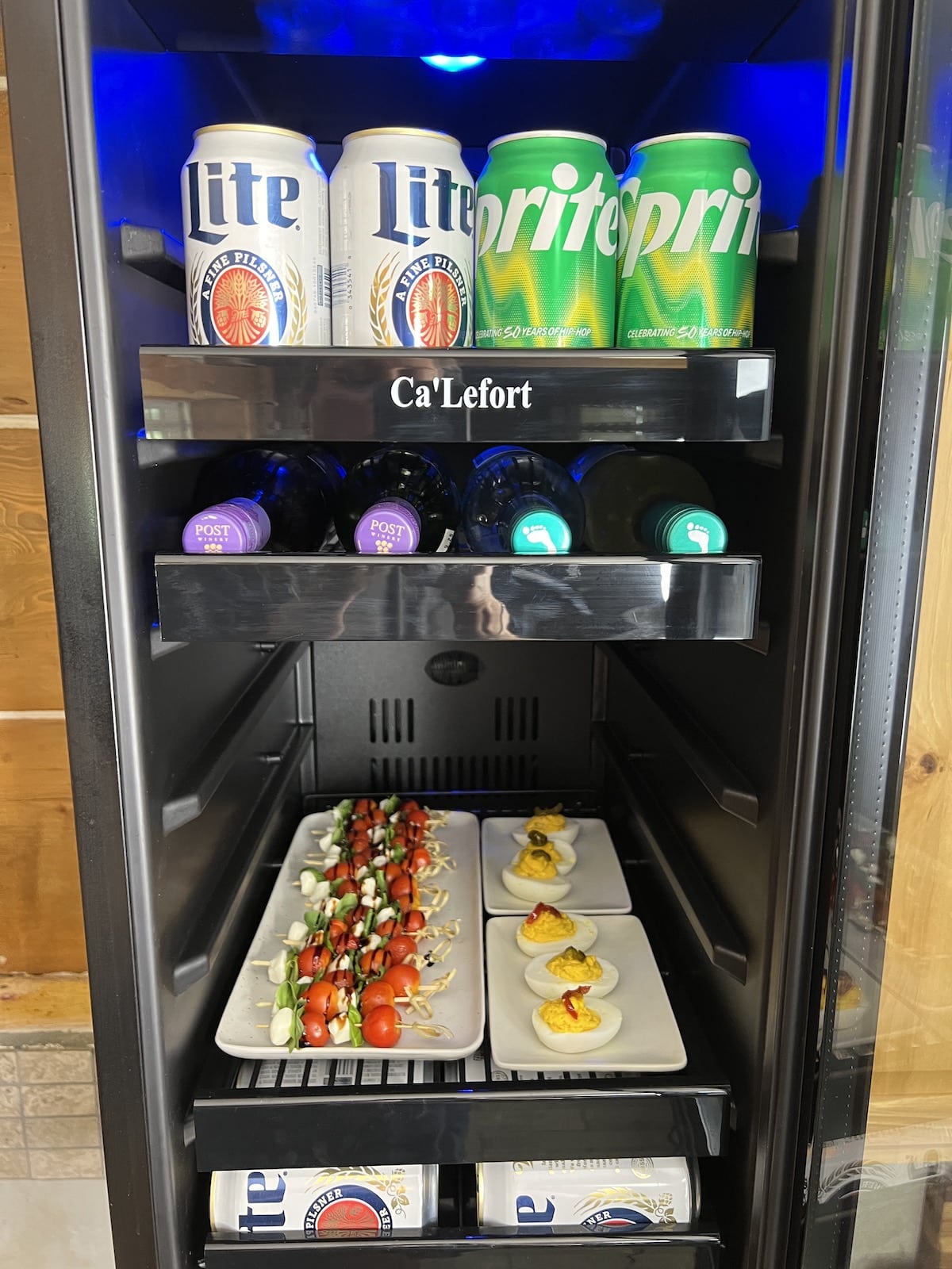 Appetizers and beer in a beverage fridge.
