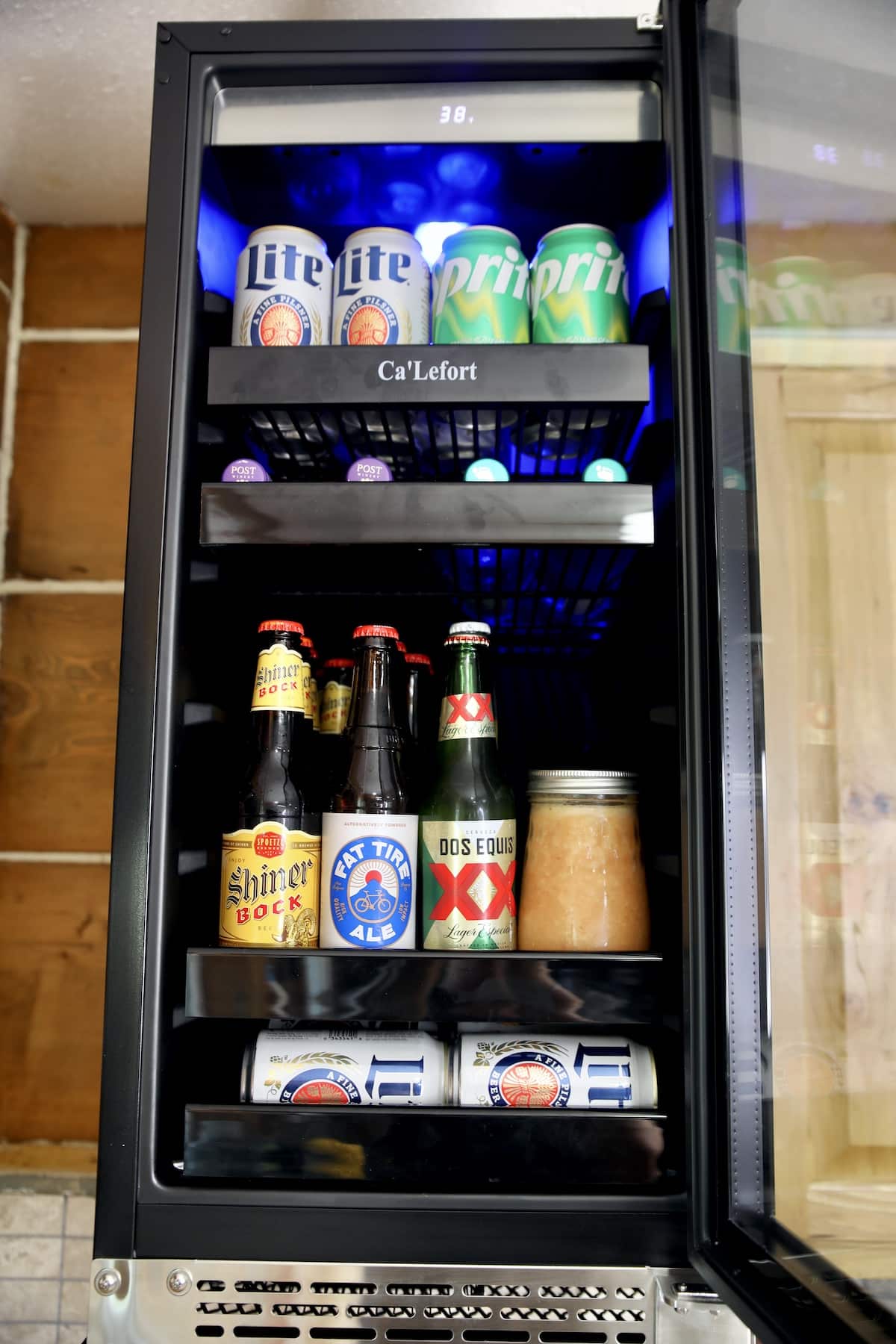 Refrigerator for beverages filled with beer, wine coolers, sprite.