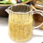 Italian dressing in a small pitcher.
