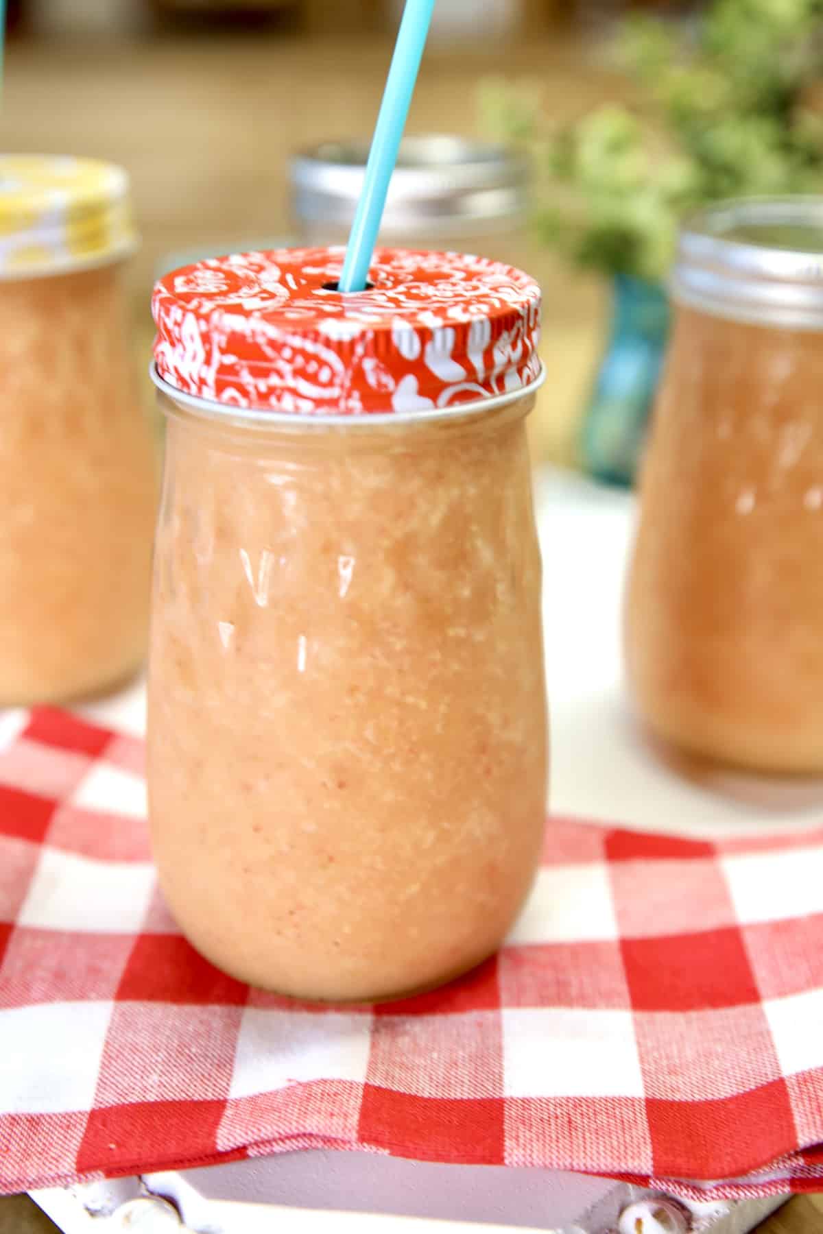 Strawberry mango wine coolers in mason jars.