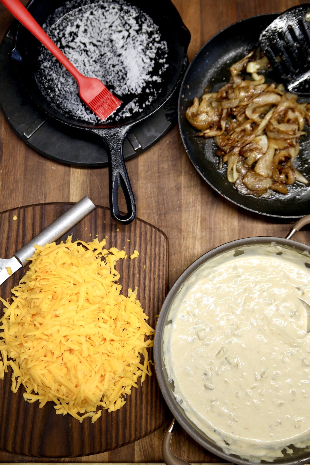 Skillet of melted butter, sauteed onions, shredded cheese, green chile sauce.
