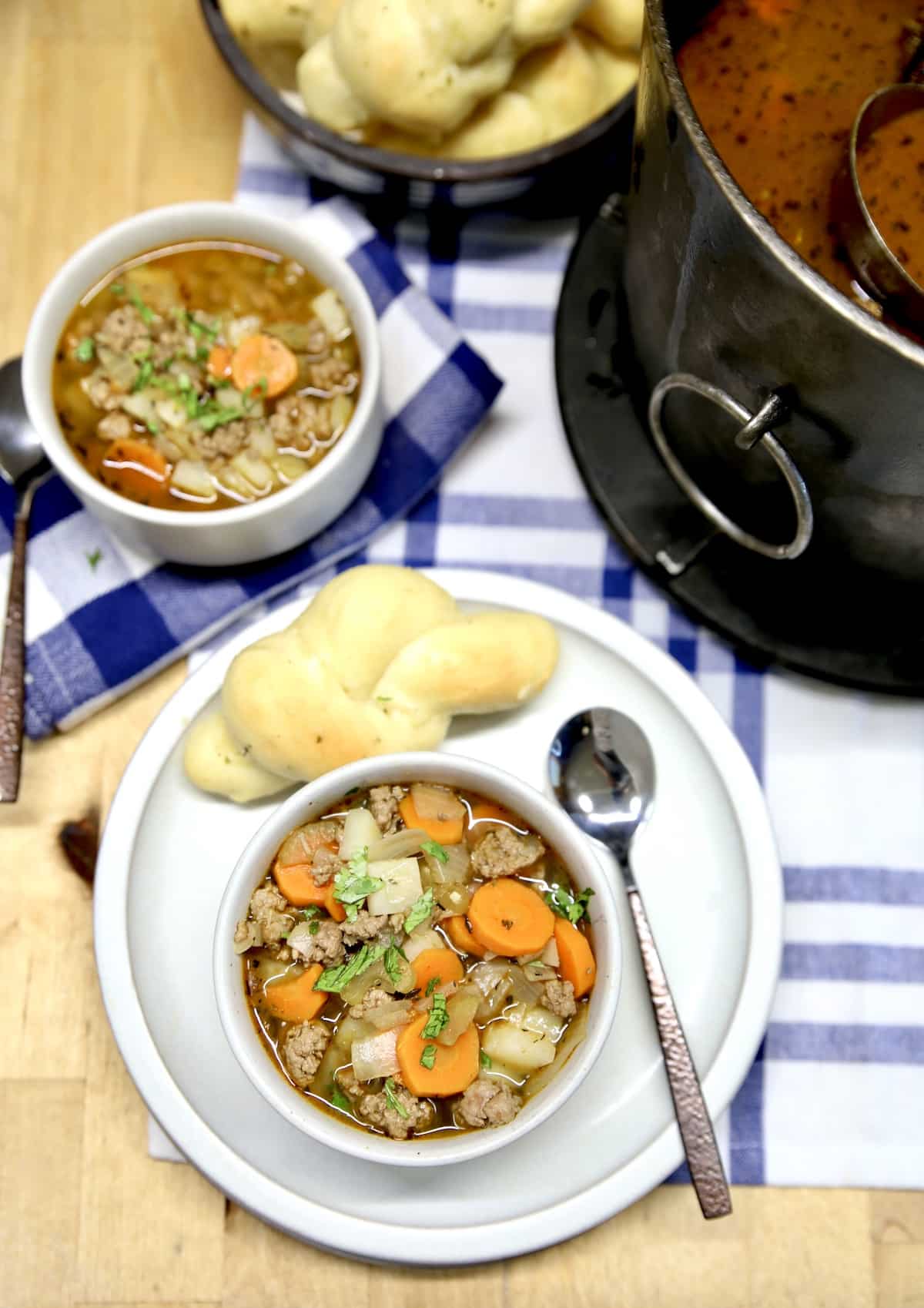 2 bowls of soup with cast iron soup pan.