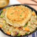 Beef pot pie with biscuits in a bowl.