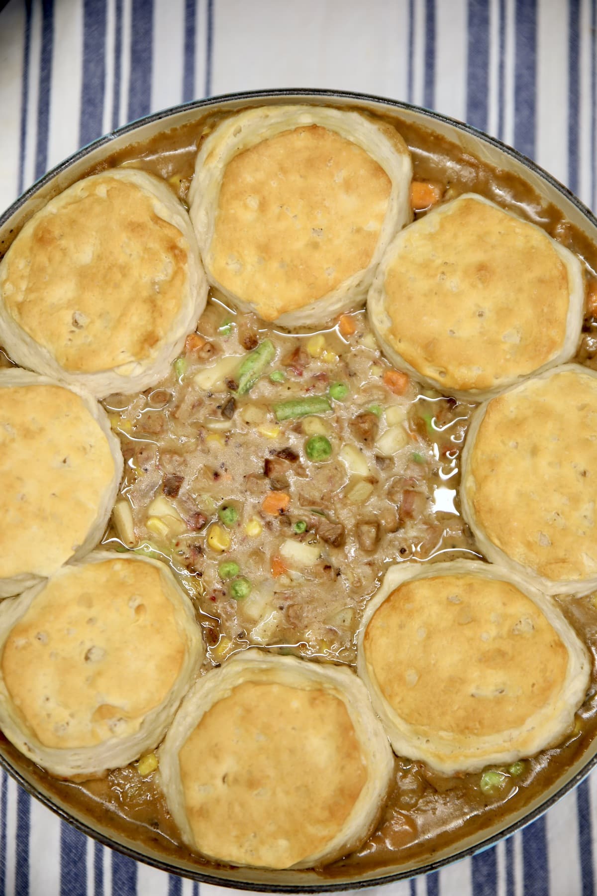 Beef pot pie in a pan with ring of Grands biscuits.