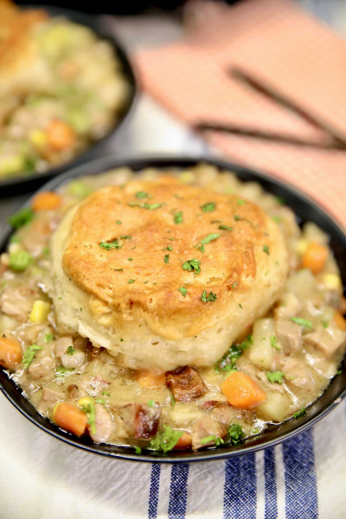 Brisket pot pie with biscuits in a bowl.