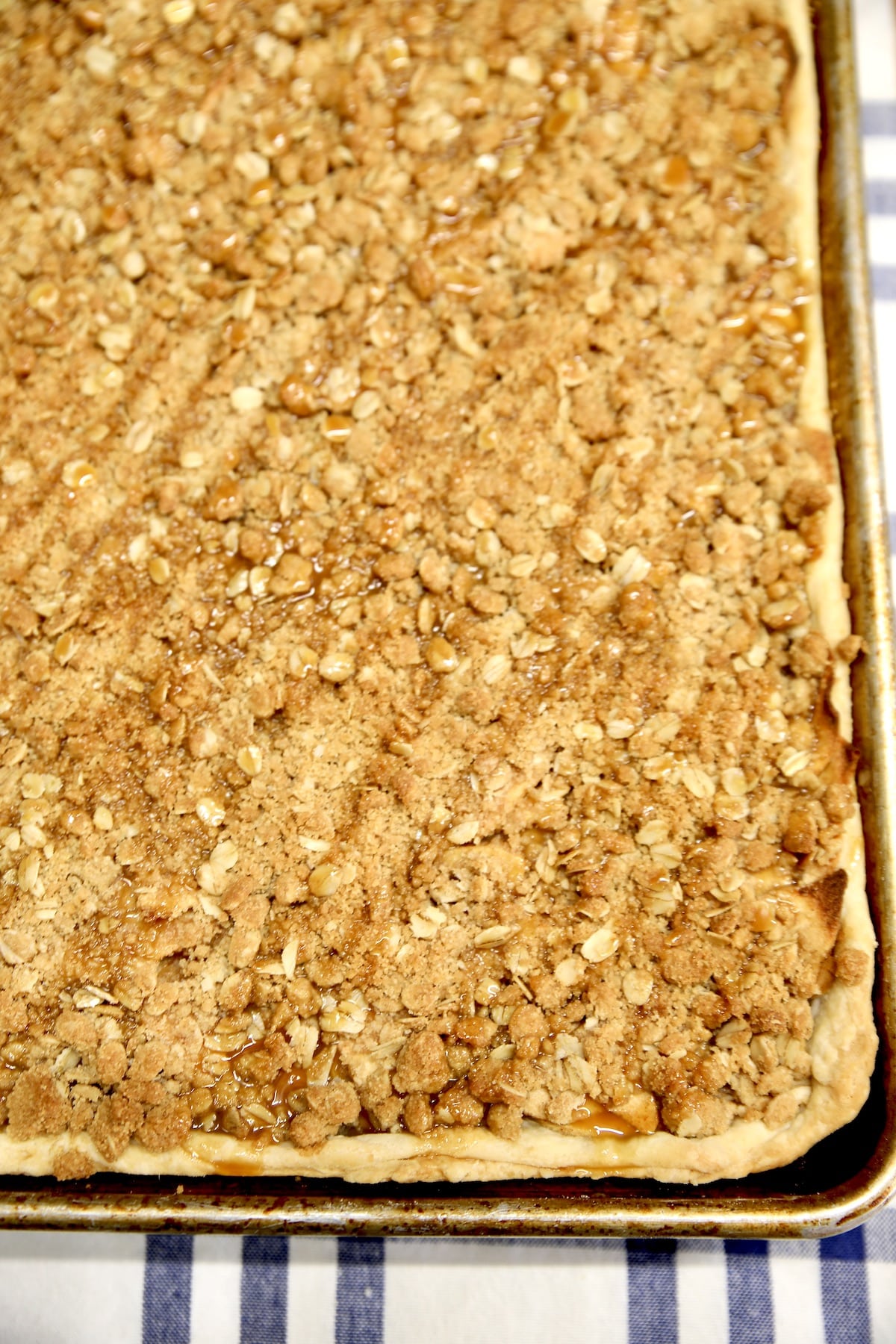 Apple slab pie with crumb topping in a sheet pan.