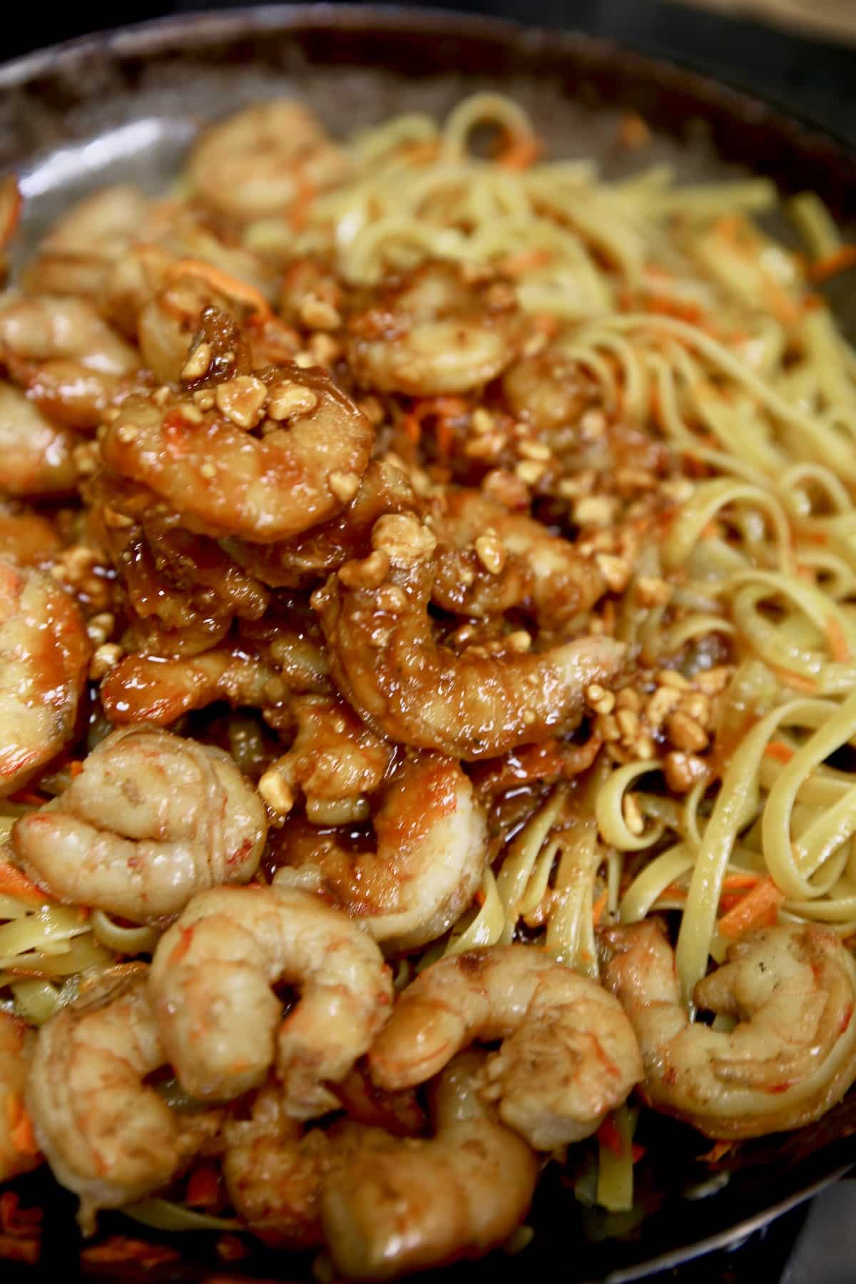 Hoisin shrimp and pasta stir fry in a skillet.