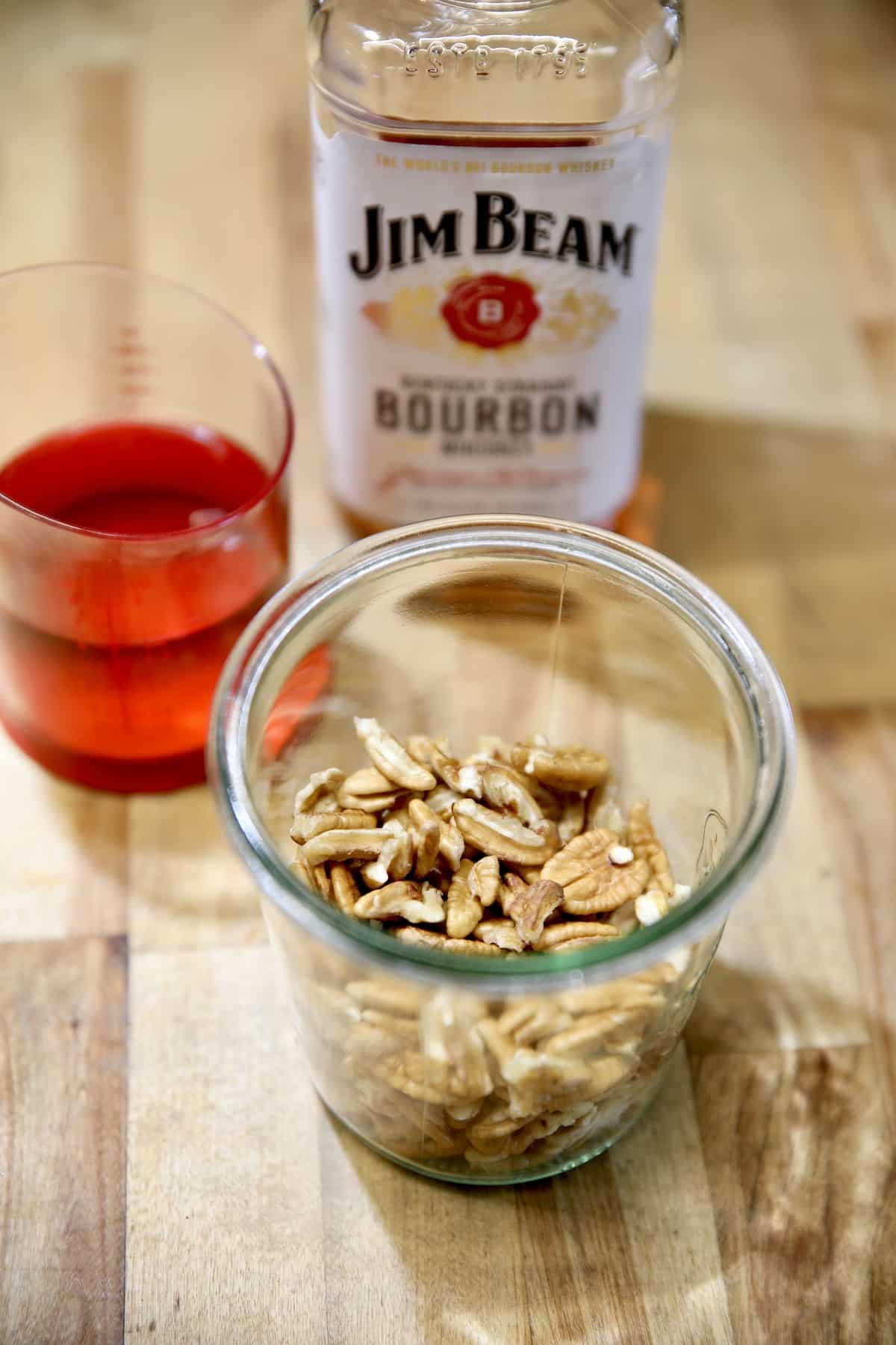Making bourbon soaked pecans for bourbon balls candy.