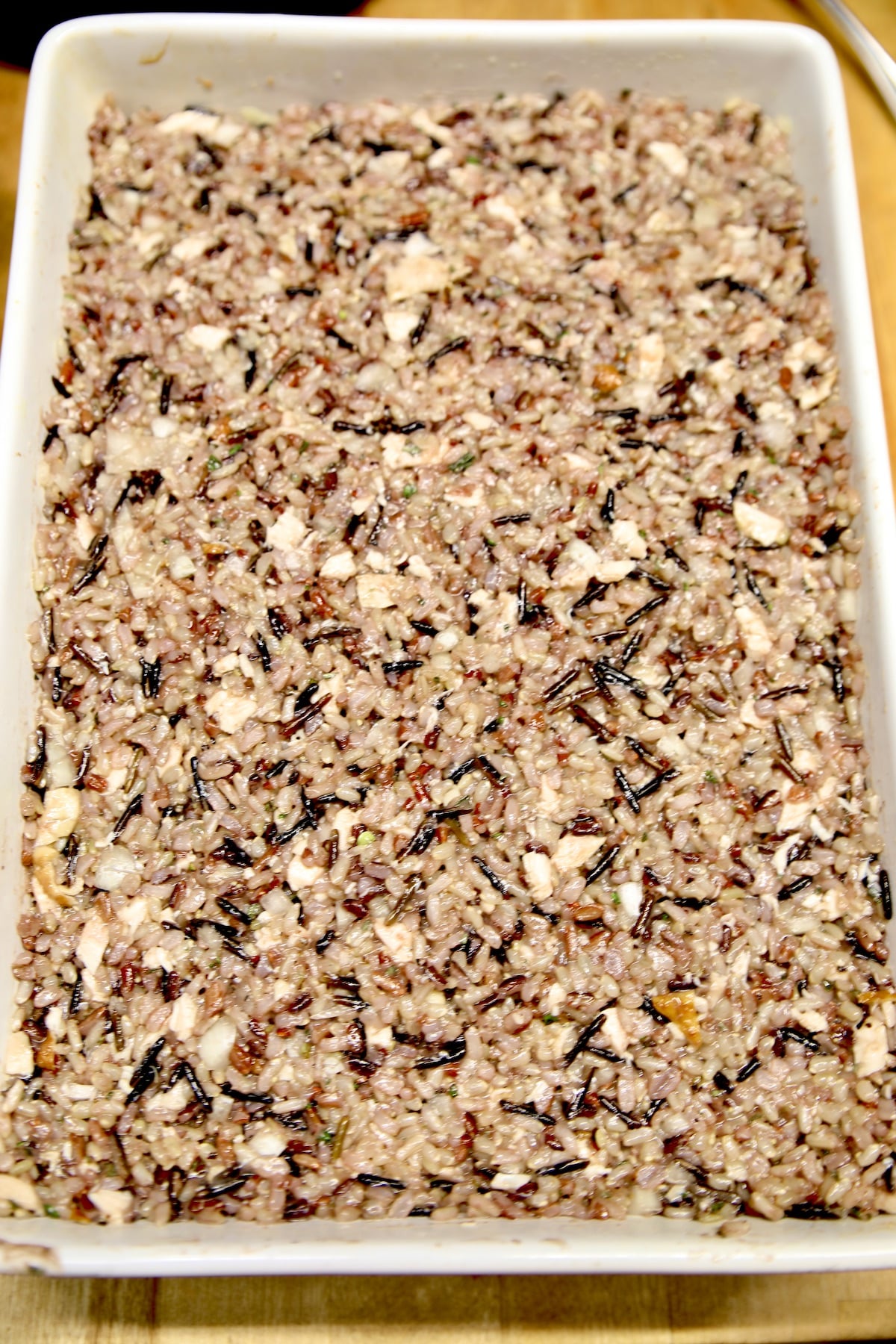Wild rice and cornbread dressing in a pan.