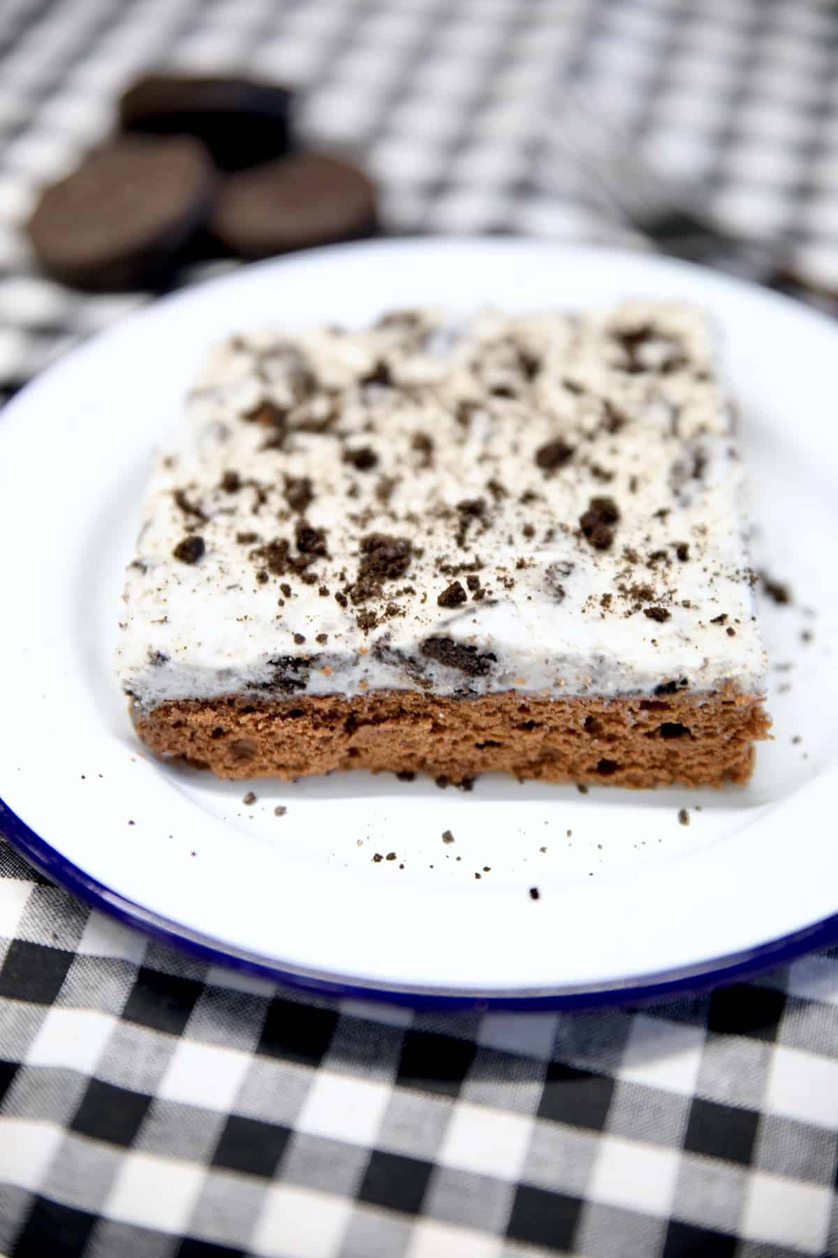 Chocolate sheet cake with oreo frosting - slice on a plate.