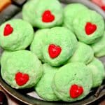 Grinch Cookies with red heart candies.