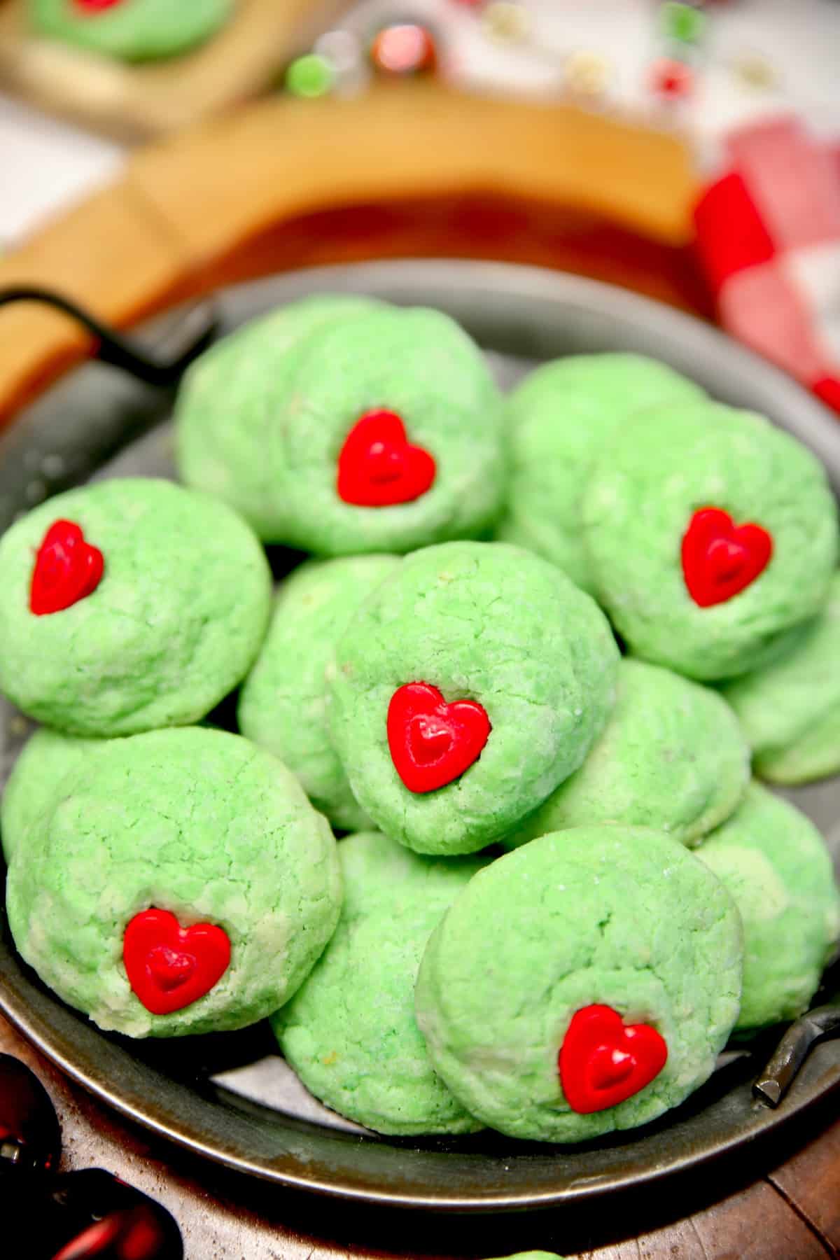 Platter of green cookies with candy hearts.