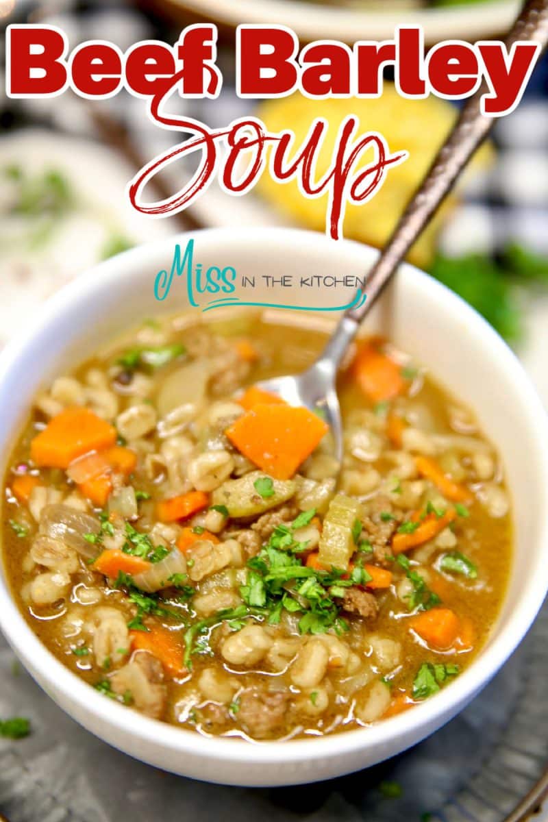 Bowl of beef barley soup with vegetables - text overlay.