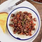 Red Beans and Rice is classic comfort food, cooked up Louisiana style for a hearty and delicious meal. Kidney beans are slow simmered with garlic, onions, bell peppers, celery and Cajun spices served over rice to create a family favorite meal.