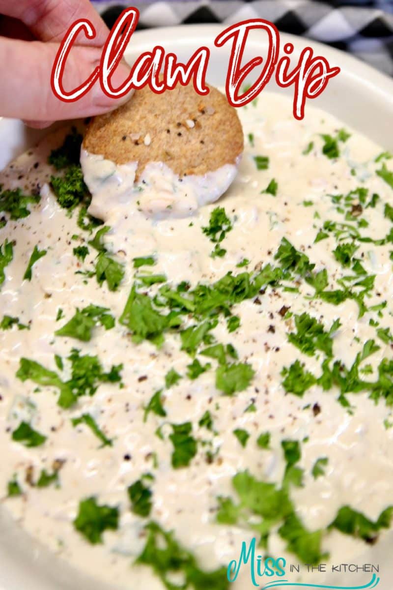 Clam Dip - dipping with cracker, text overlay.