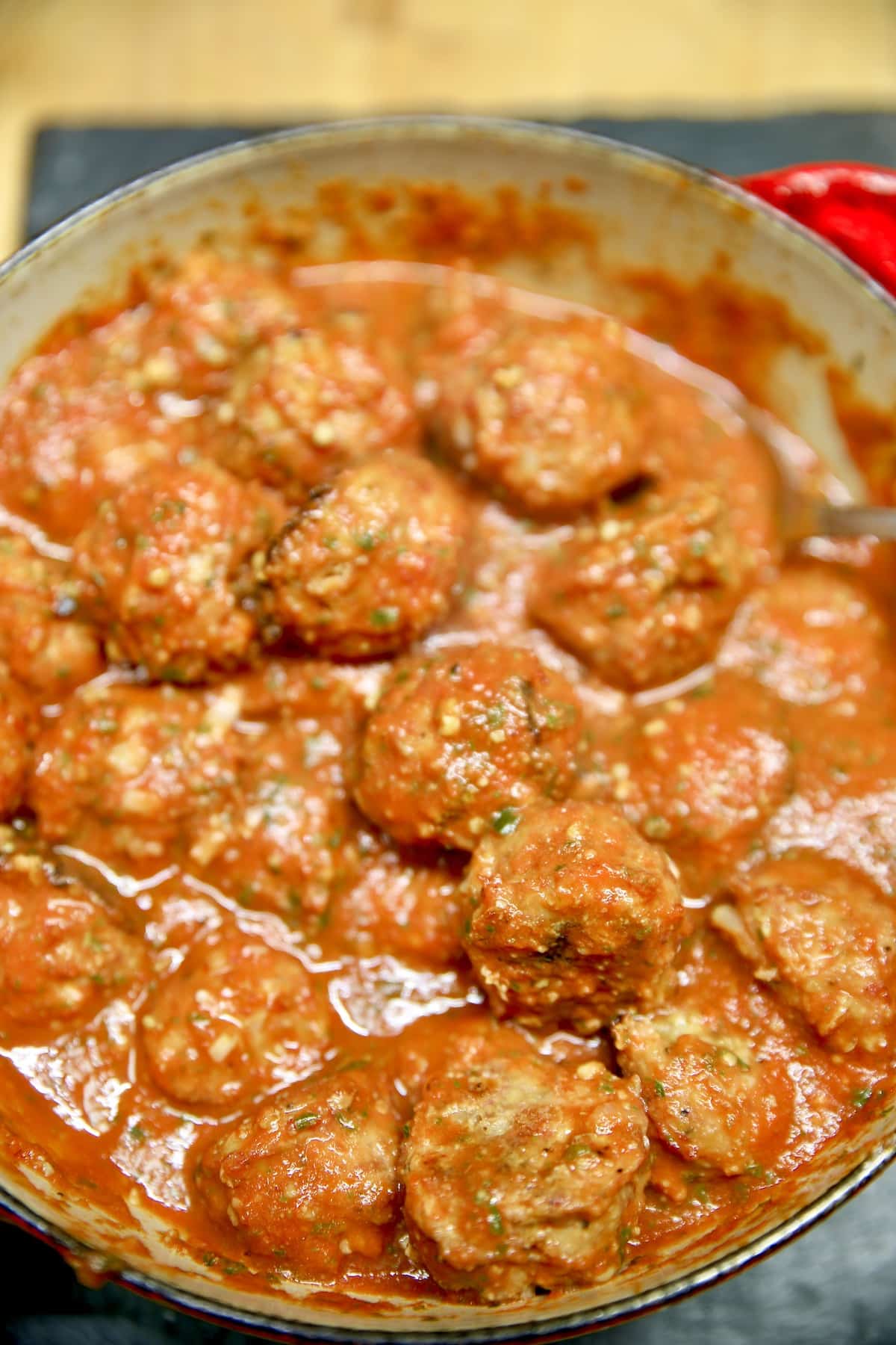 Pan of meatballs in marinara sauce.